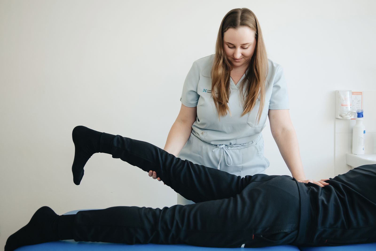 A physiotherapist guiding a patient through a session