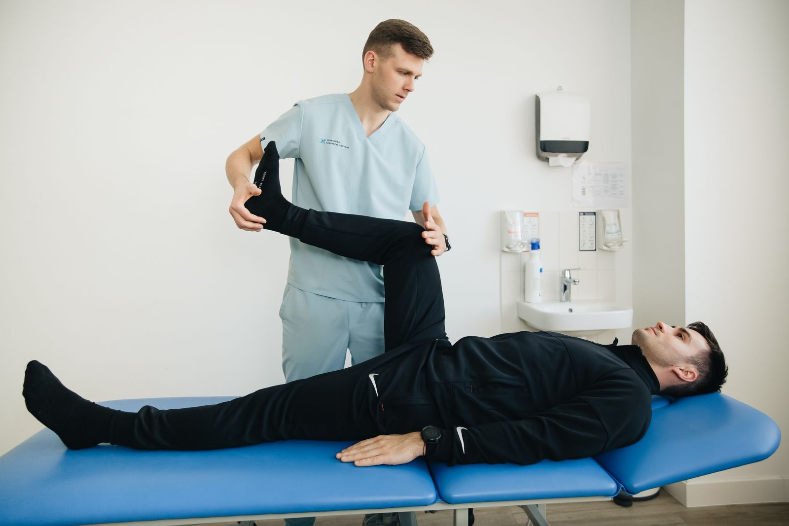 A physiotherapist and patient exercising